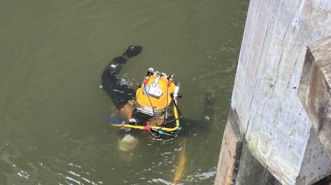 A diver in the water on the canal