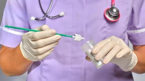 Stock image of nurse holding smear test