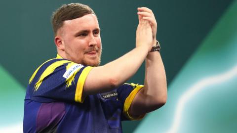 Luke Littler applauds
