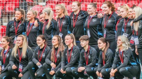 Members of the Thornaby FC women's team, seated and standing and wearing full kit