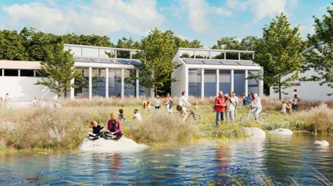 An artists CGI mock-up of Salt Cross garden village. It depicts modern white buildings overlooking a green open space with a pond in the middle.