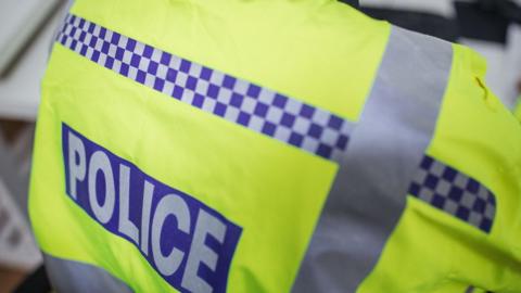 A stock photo of a police officer's florescent jacket.