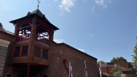 A bell tower on top of a foundry building