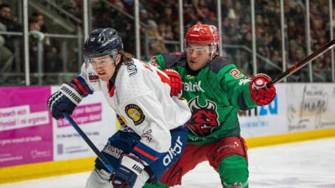 Jonathan McBean of Dundee Stars battles for possession against Connor Caponi of Cardiff Devils