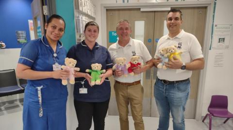 The chairman and deputy chairman of TLC Surrey with paediatric nurses