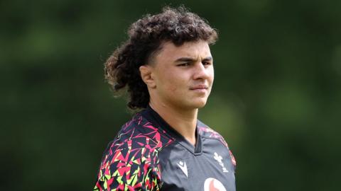 Kane James in training kit with Wales
