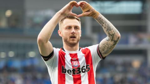 Stoke City's Ben Wilmot holds his hands in a heart shape towards the fans after the 1-0 win at Cardiff