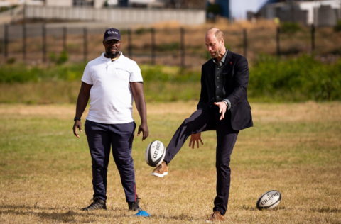 The Prince of Wales kicks a ball while taking part in a rugby coaching session with local school children during a visit to Ocean View Secondary School in Cape Town, South Africa.