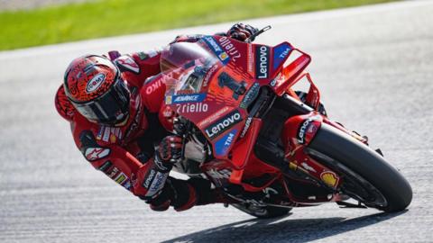 Francesco Bagnaia on his motorbike, leaning around a corner during a race