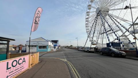 The seafront in Felixstowe, with a big wheel on the right.
