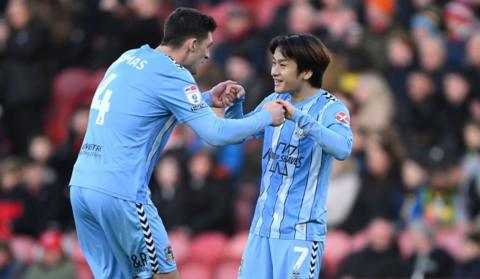 Bobby Thomas celebrates his first Coventry goal of the season with Tatsuhiro Sakamoto  