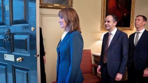 Chancellor of the Exchequer Rachel Reeves followed by Treasury team members, Chief Secretary to the Treasury James Murray, and Financial Secretary to the Treasury Lord Spencer Livermore are seen as they prepare to leave 11 Downing Street on November 26, 2025 in London, England.
