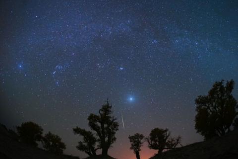 night sky with stars and meteor.