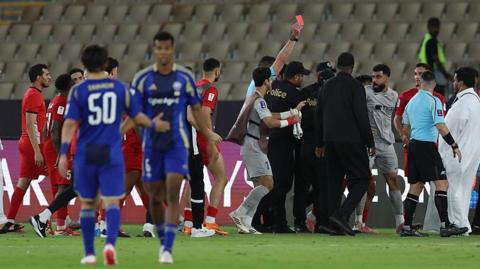 Shabab Al-Ahli players speak to referee Shaun Evans after their AFC Champions League semi-final loss to Machida Zelvia