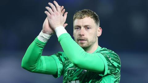 Close-up of Birmingham City goalkeeper Ryan Allsop clapping the crowd with his arms above his head