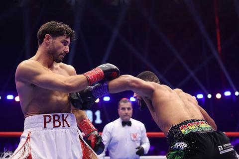 Josh Kelly lands a punch on Caoimhin Agyarko