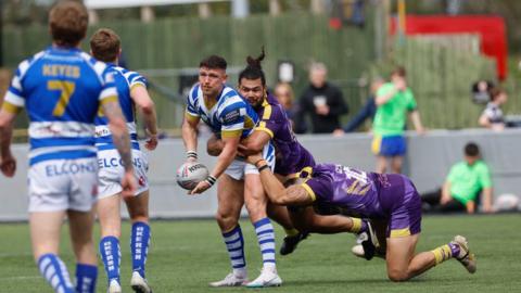 Zack McComb of Halifax Panthers looks to offload in the tackle during the BETFRED Championship 