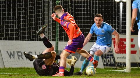 A goalmouth scramble