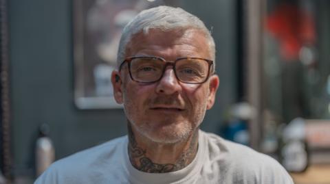 Matthew Pritchard wearing glasses and w white t shirt