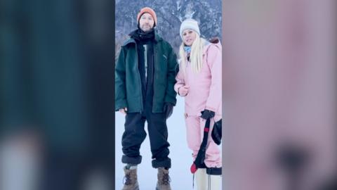 Ed Leigh and Chemmy Alcott stand on the snow wearing winter clothing