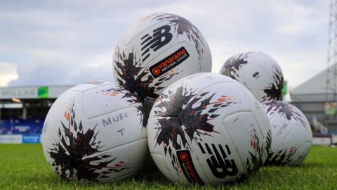 A pile of National League matchballs