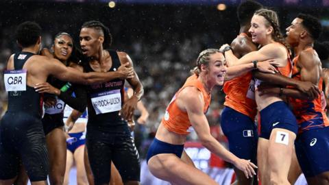 Great Britain and the Netherlands teams celebrate their respective mixed 4x400m relay medals