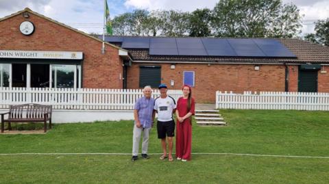 Councillor Geoffrey Seef, left, cricket club chairman Rob Ashwell, middle, and councillor Alex Bulat, right, standing in front of the cricket pavilion