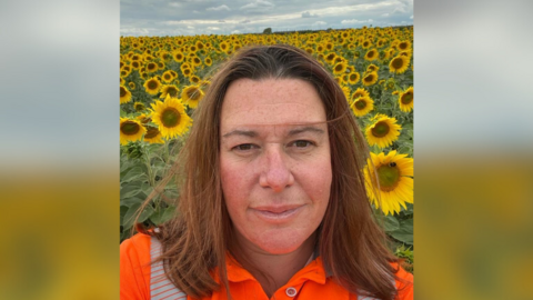 Helen Creed standing in the sunflower patch