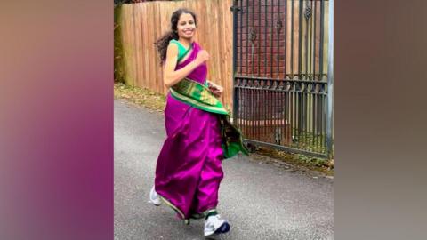 Madhusmita Jena running in a pink and green sari