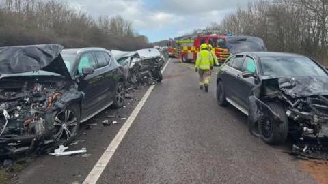 The wreckage of three vehicles on the road after a crash