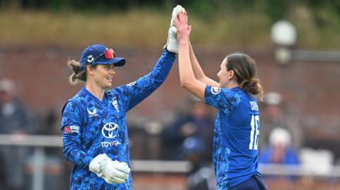 Kate Cross and Amy Jones celebrate a wicket