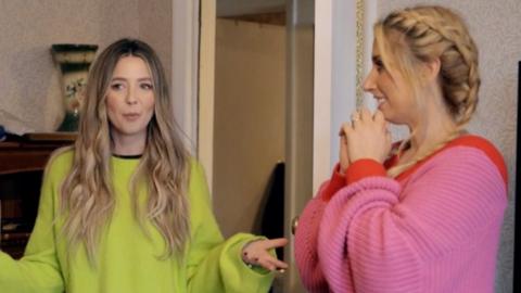 Zoe Sugg and Stacey Solomon stand in a living room