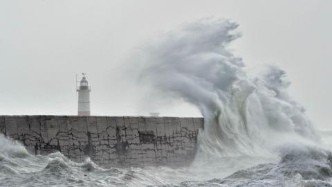 Large waves crashing on Newhaven Breakwater Light at Newhaven Harbour, East Sussex