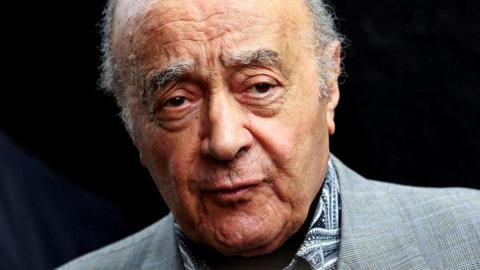 A close up photo of disgraced former owner of Harrods Mohamed Al Fayedm in a grey suit. 