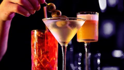 Three cocktails placed on a bar.