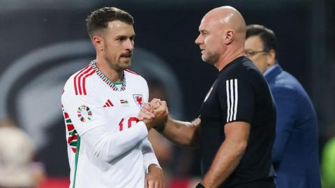 Aaron Ramsey (left) shakes hands with Robert Page