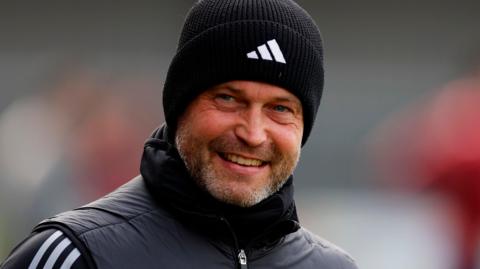 Exeter City assistant coach Kevin Nicholson smiling.