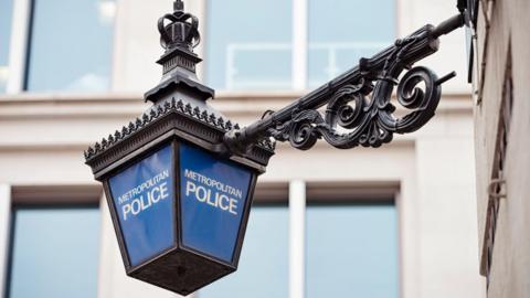 A lantern with the words Metropolitan Police in white lettering