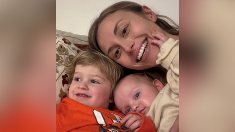 Joanna Cozon with her children. She is taking a selfie with her three year old and baby.