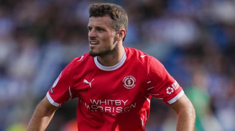 Josh March in action for Crewe in the club's red home shirt