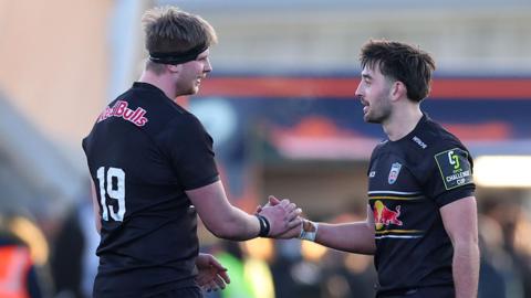 Newcastle players Finn Baker (left) and Ethan Grayson slap right hands together in congratulating each other during win over Perpignan 