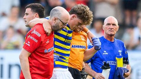 Arron Lindop is helped off the field by medics against Catalans Dragons