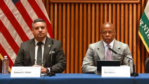 NYPD Commissioner Edward Caban seated next to New York Mayor Eric Adams