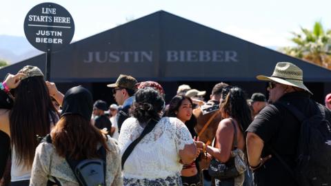 Justin Bieber fans line up in front of his store during the 2026 Coachella festival