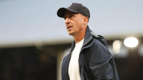 Gerhard Struber walks with his hand in his pocket at the end of a match