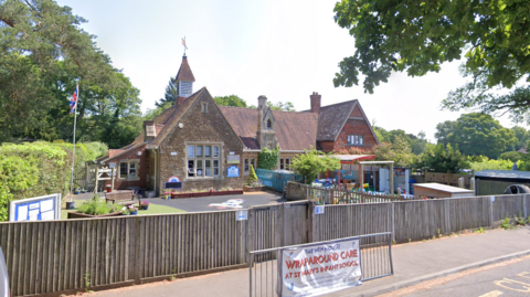 A rural village school on a sunny day. 