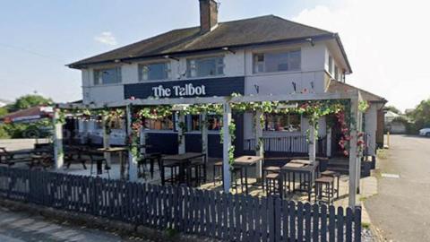 The Talbot on Balshaw Lane in Euxton. A large detached white two storey pub with pergolas and seating to the front