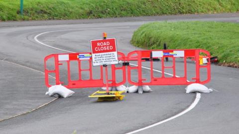 Road closed sign and barriers at the top of Le Val des Terres, Guernsey