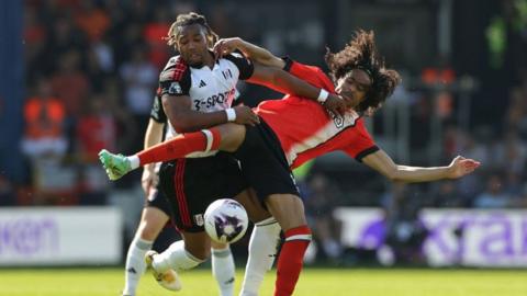 Tahith Chong of Luton Town is challenged by Adama Traore of Fulham during the Premier League match between Luton Town and Fulham