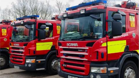 A stock image of fire engines parked in a row. 